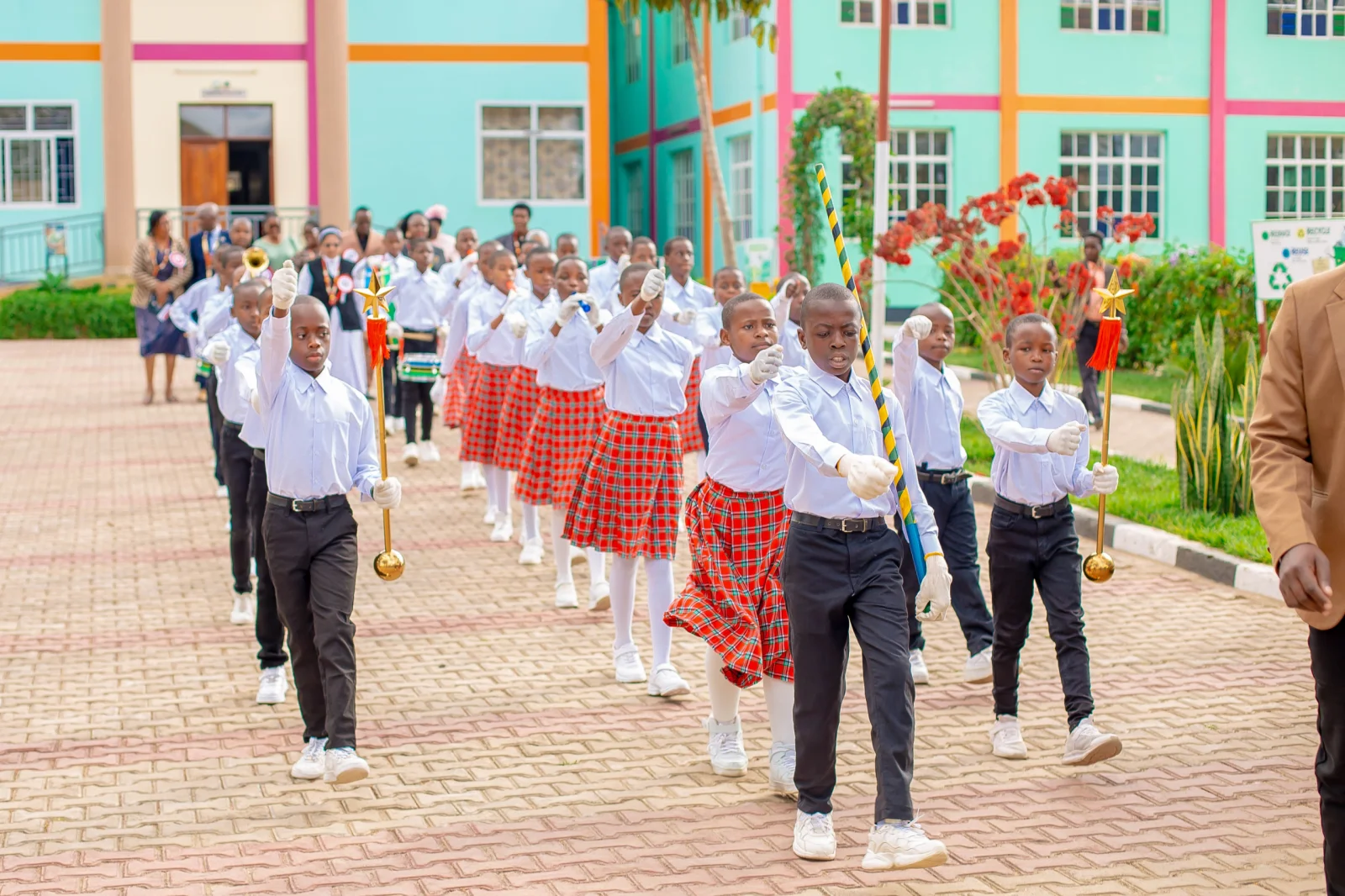 Graduates forming a ceremonial welcome line during the 2026 school graduation.